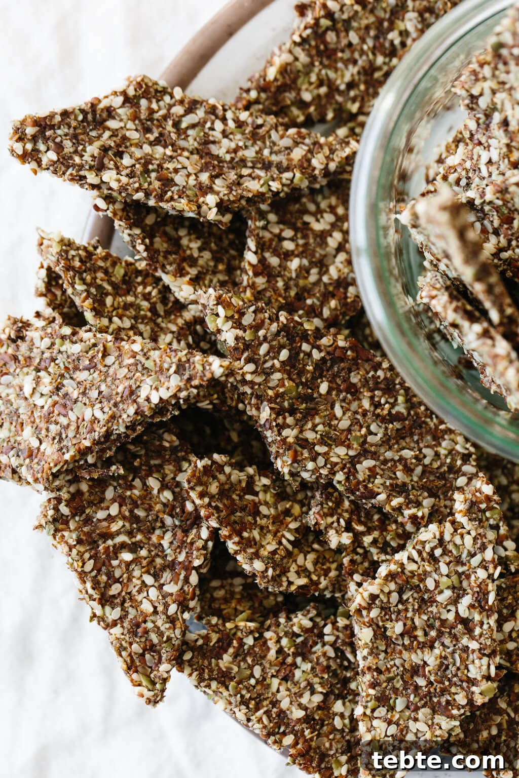 Flax seed crackers are a crunchy, flavorful, homemade cracker recipe that's naturally gluten-free, grain-free, nut-free, paleo and vegan. Made from flax seeds, chia seeds, sesame seeds and pumpkin seeds, they're super easy to make and great for snacking.