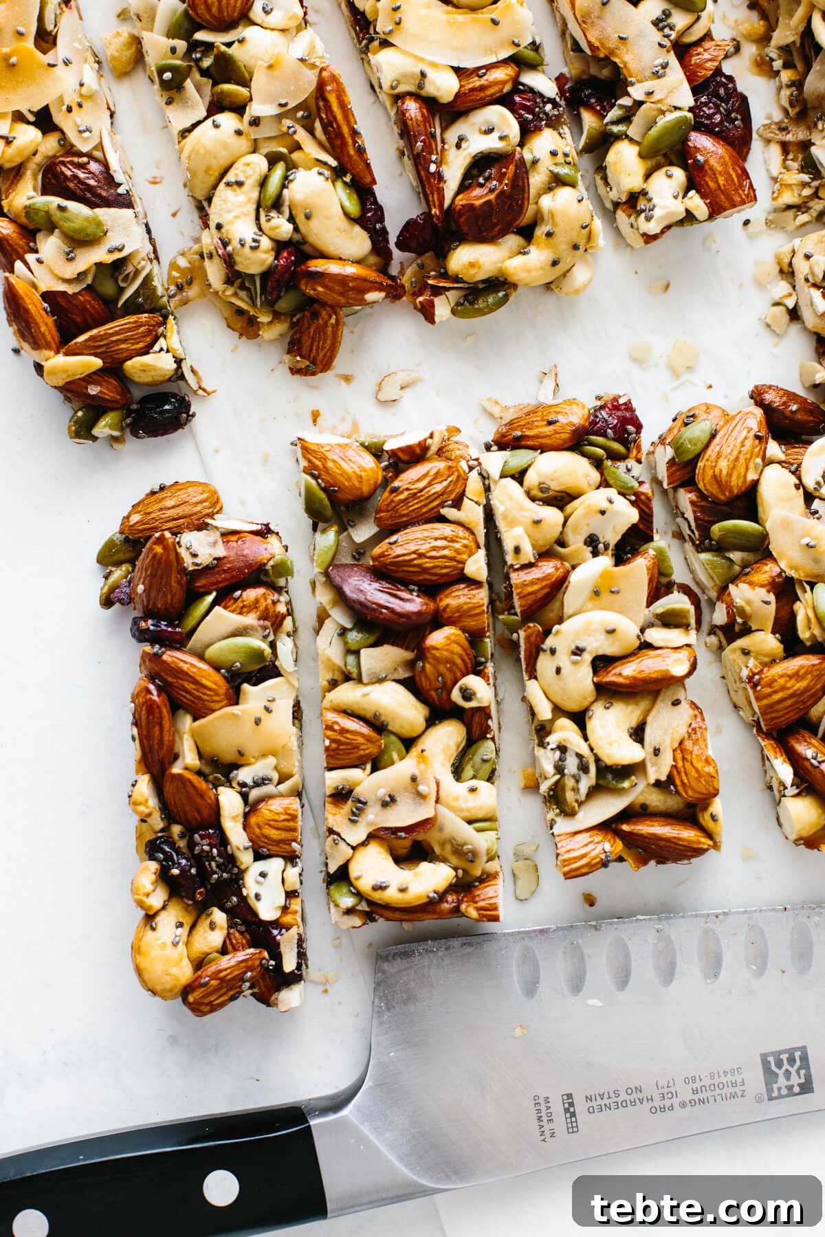 Trail mix bars cut into individual bars next to a knife.