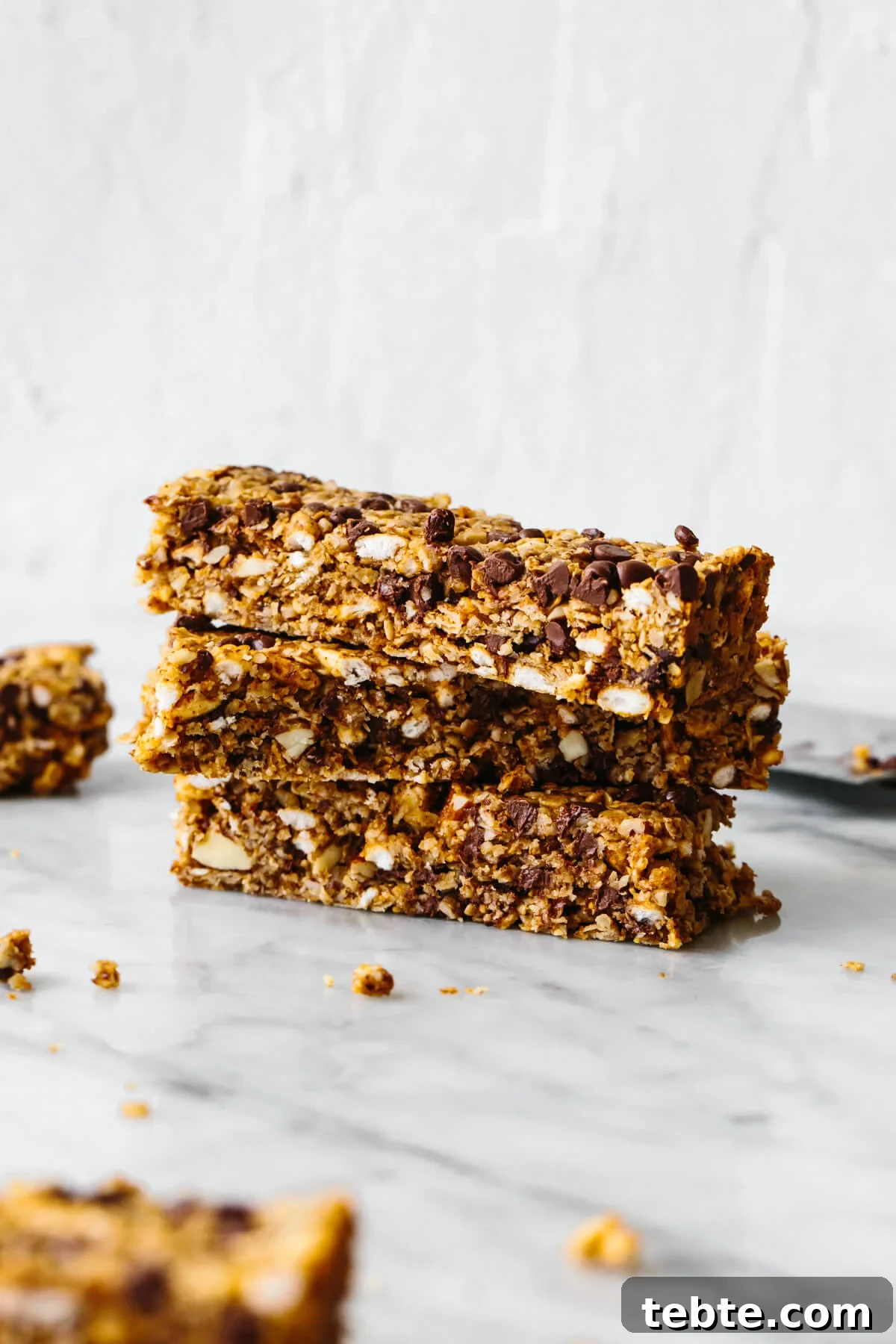 Chewy chocolate granola bars stacked on a table