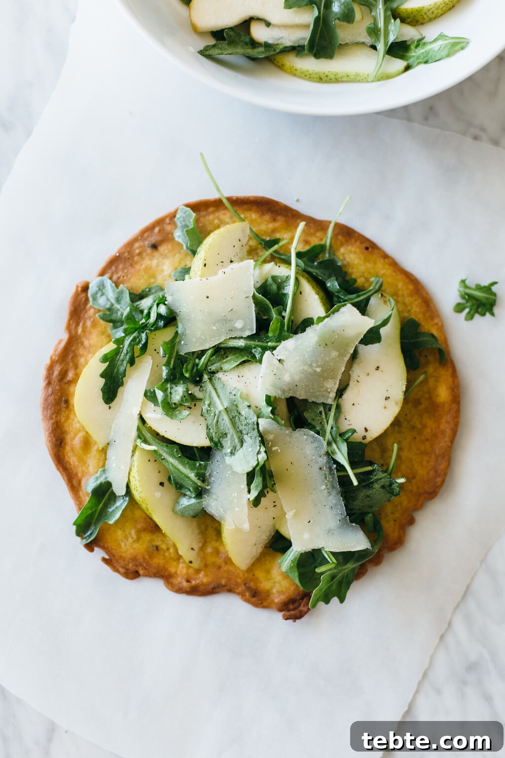 (gluten-free, grain-free) Crispy socca with pear and arugula salad. Made with chickpea flour, this crispy socca becomes the perfect base for a delicious and healthy salad.