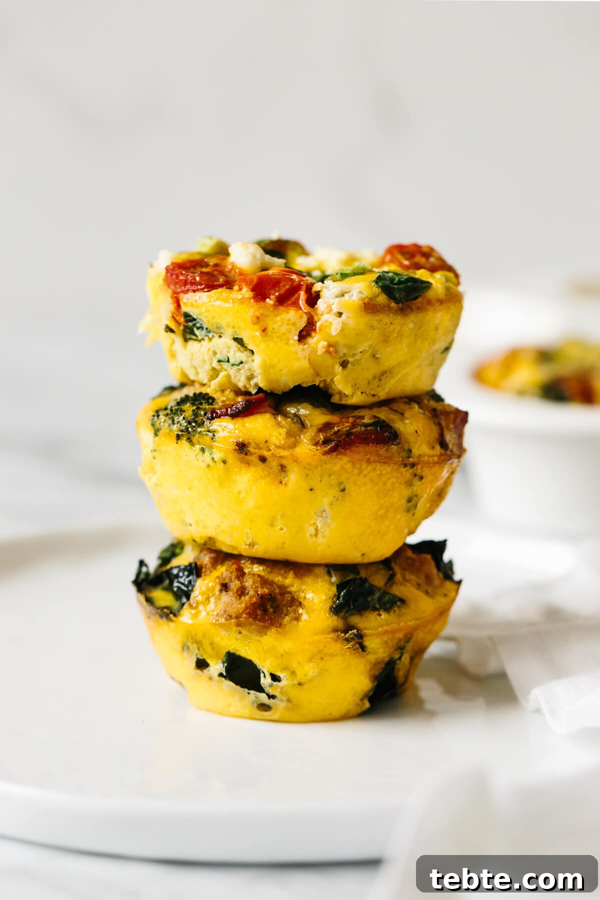 Three egg muffins stacked on top of each other.