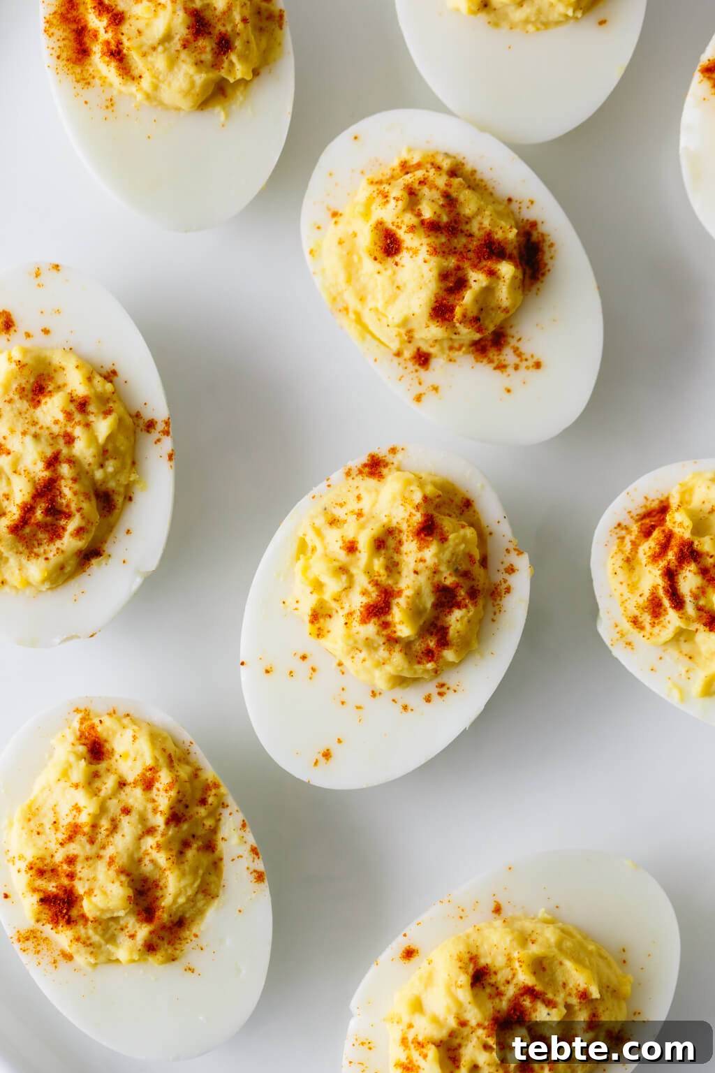 Deviled eggs on a white plate.