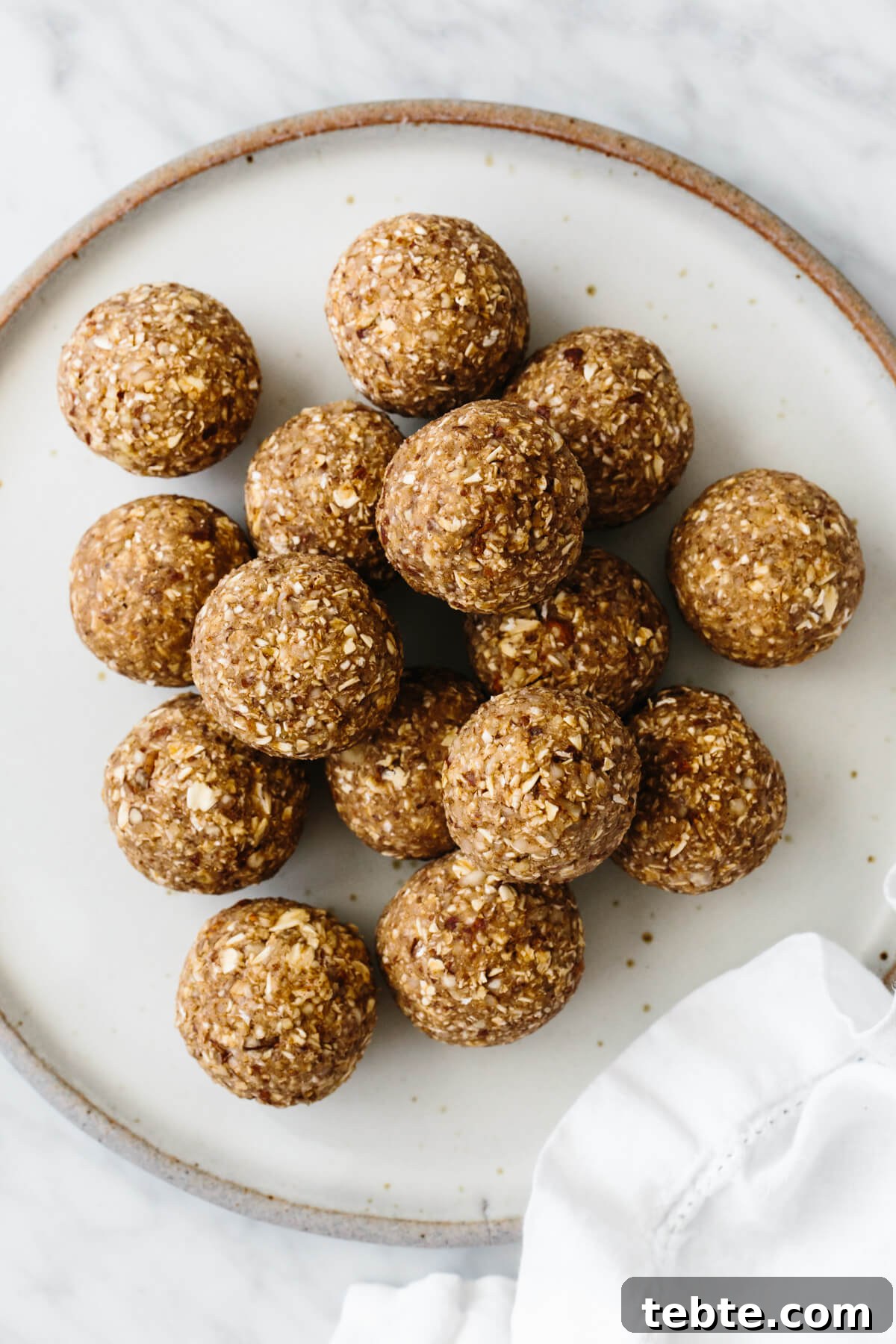 A stack of energy balls on a white plate.