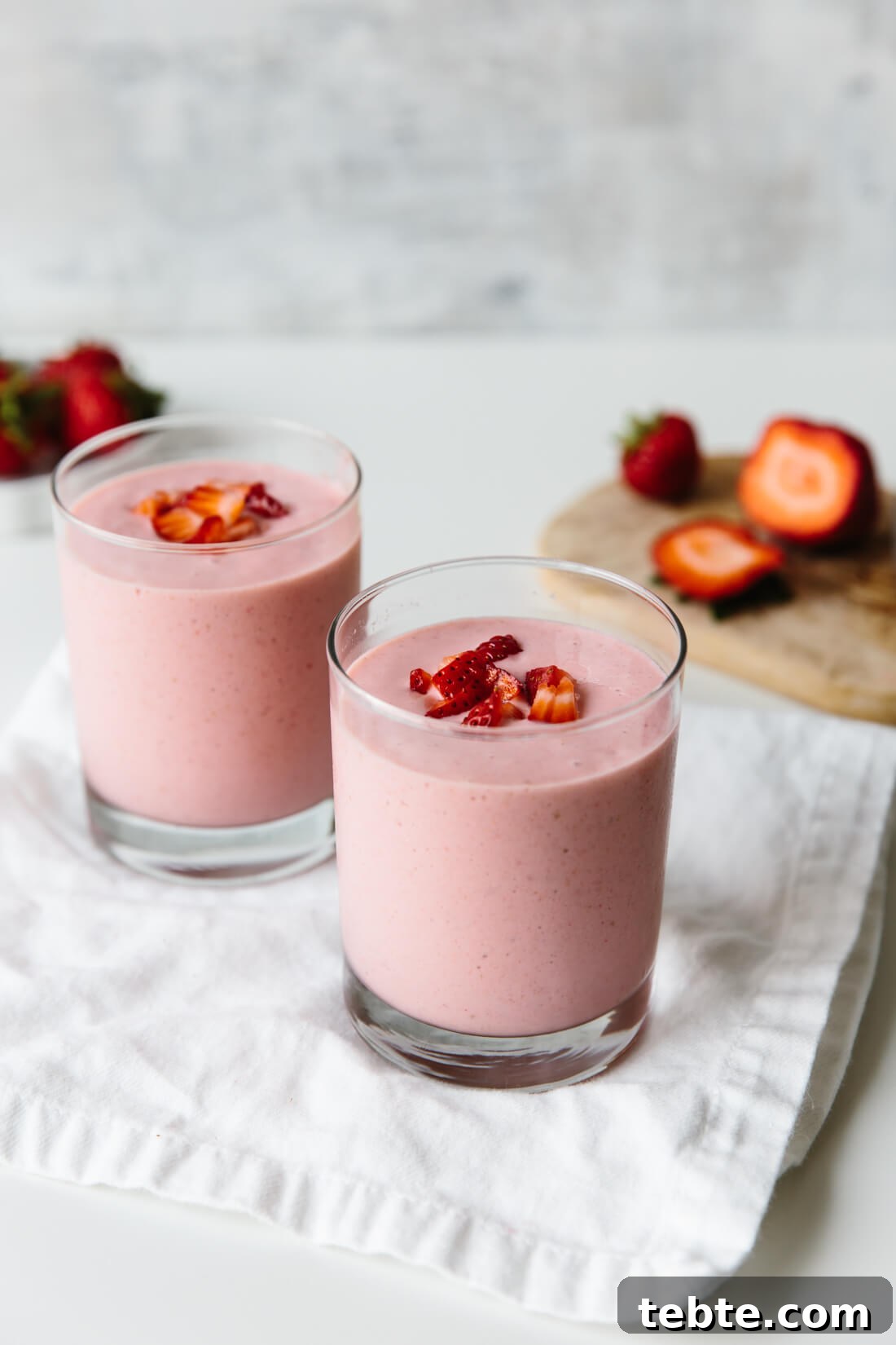 Two glasses of strawberry banana smoothie.