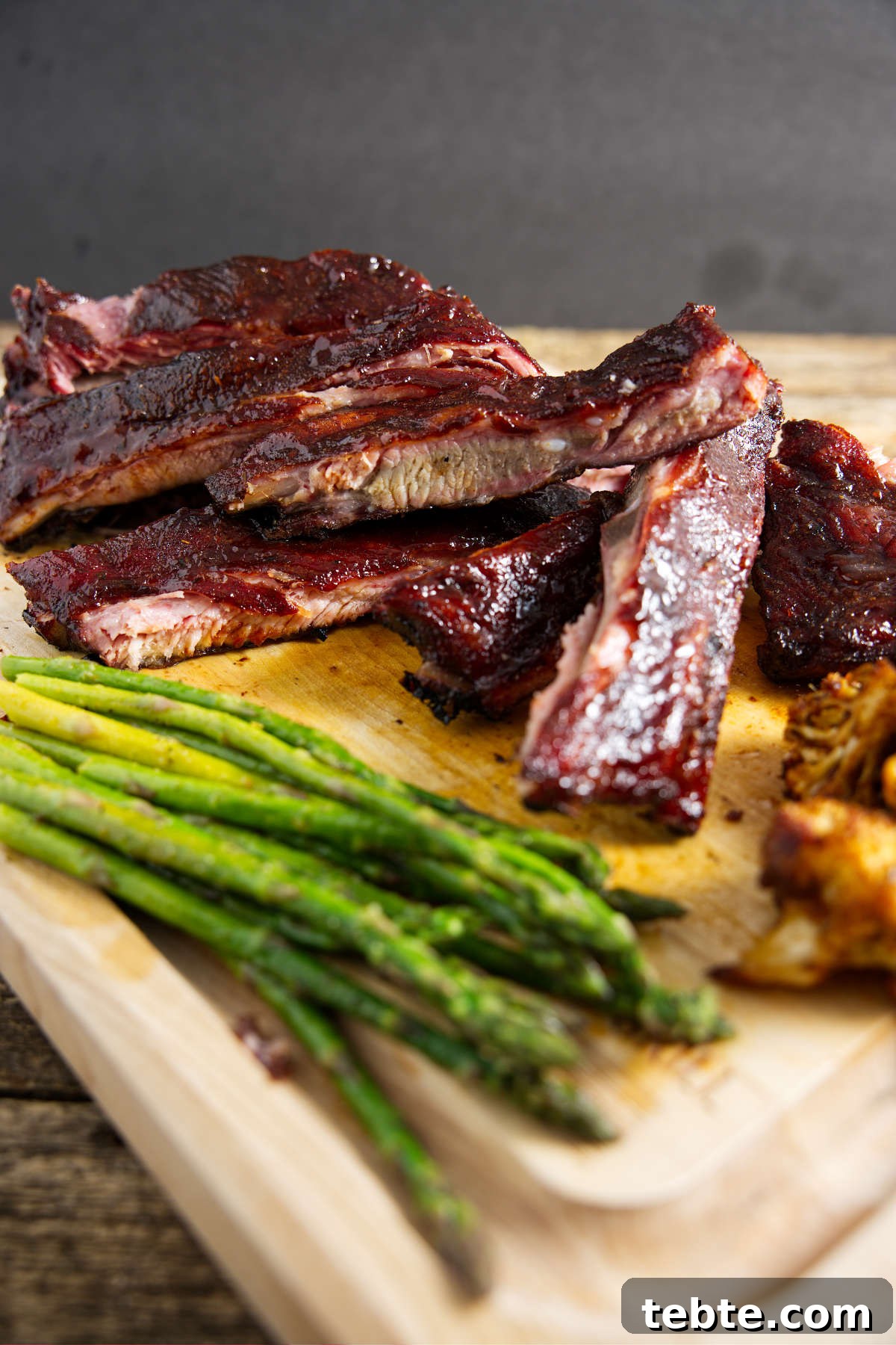 3-2-1 Smoked Ribs Recipe: Perfect Tender Fall-Off-the-Bone Ribs 3 sliced pork 3-2-1 ribs on butcher board