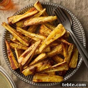 Crispy Roasted Parsnips with Honey and Rosemary 8 A bowl filled with golden roast parsnips, ready to serve.