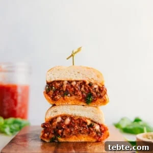Classic Italian Sausage Sandwich with Peppers and Onions 3 Italian Sausage Sandwich cut in half and stacked on top of each other showing the delicious insides.