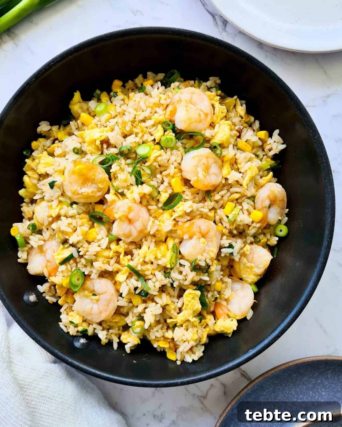 Garlic Shrimp Fried Rice Recipe – Quick Weeknight Stir-Fry 7 Freshly made fried rice in a black frying pan