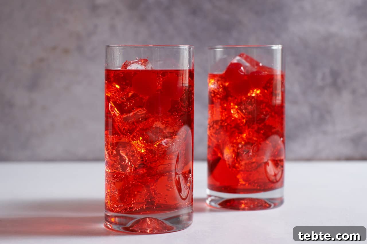 Dirty Shirley Cocktail Recipe: Spiked Shirley Temple Guide 2 Two Dirty Shirley cocktails in tall drink glasses garnished with maraschino cherries.
