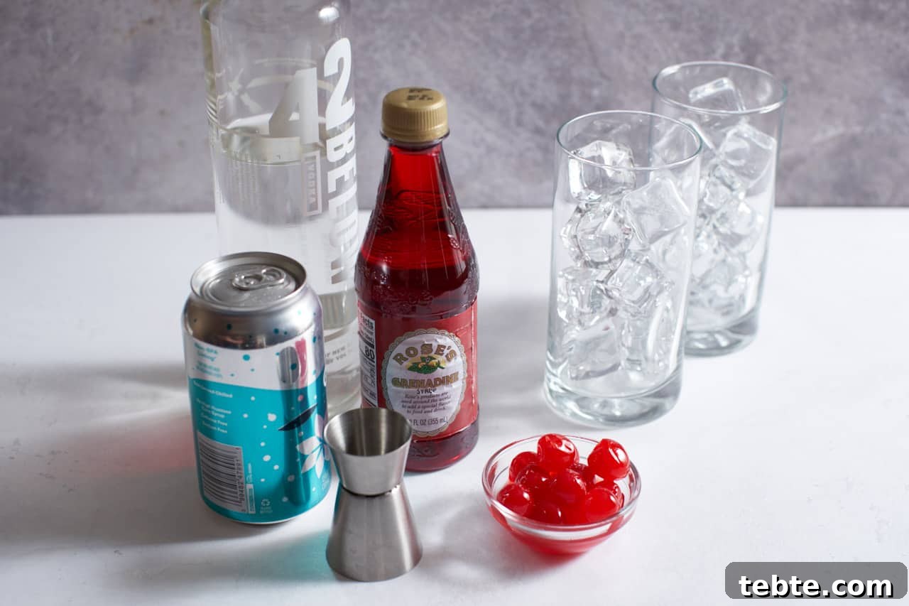 Dirty Shirley Cocktail Recipe: Spiked Shirley Temple Guide 3 A can of soda, bottles of vodka and grenadine, a cocktail jigger, a bowl of maraschino cherries and two high ball glasses full of ice.