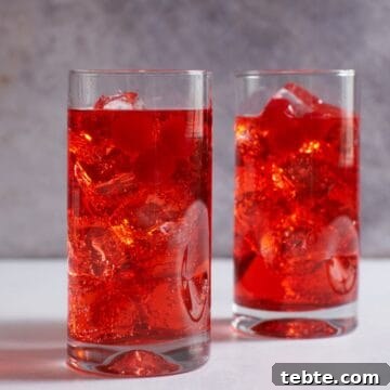 Dirty Shirley Cocktail Recipe: Spiked Shirley Temple Guide 5 Two Dirty Shirley cocktails in tall drink glasses garnished with maraschino cherries.