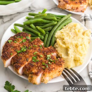 Hawaiian-Style Grilled Pork Chops with Pineapple Glaze 14 Parmesan breaded pork chops on a plate with mashed potatoes and green beans