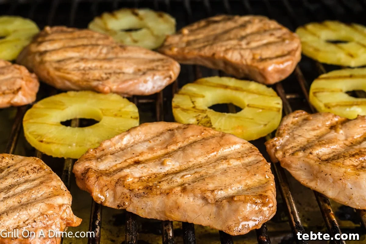 Hawaiian-Style Grilled Pork Chops with Pineapple Glaze 7 Grilling pork chops and slice pineapple on the grill.