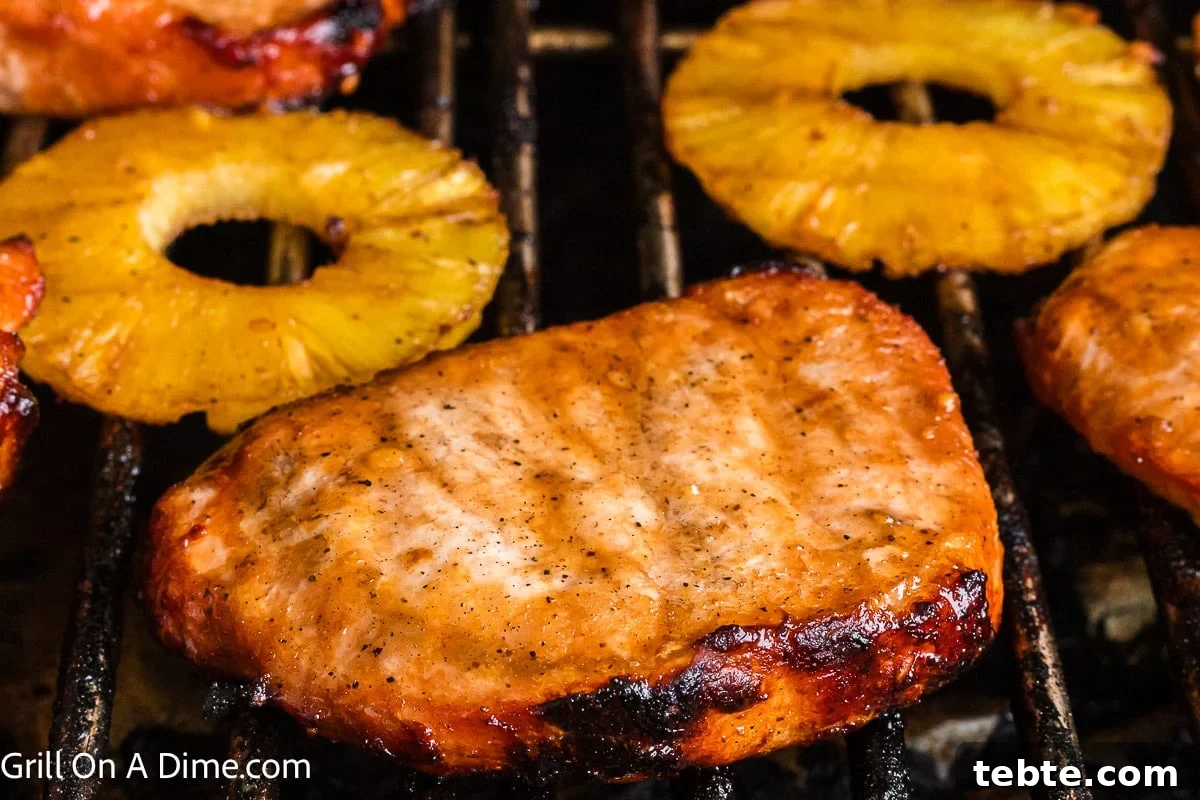 Hawaiian-Style Grilled Pork Chops with Pineapple Glaze 8 Grilled pork chops and grilled pineapple on the grill.
