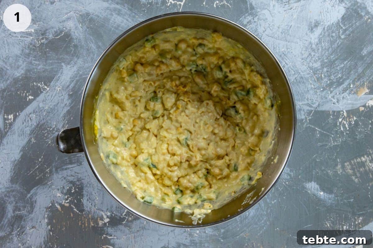 Batter mixed up in stainless steel bowl.