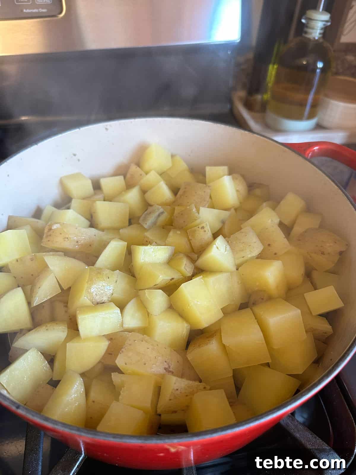 Twice-Baked Potato Casserole: Loaded Mashed Potato Bake 4 Diced cooked potatoes in a pot on the stove.