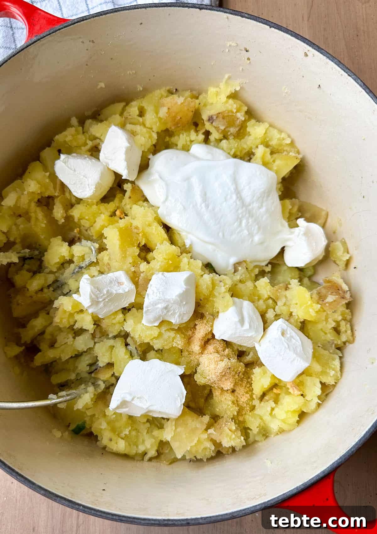 Twice-Baked Potato Casserole: Loaded Mashed Potato Bake 6 Cream cheese and sour cream on top of mashed potatoes.