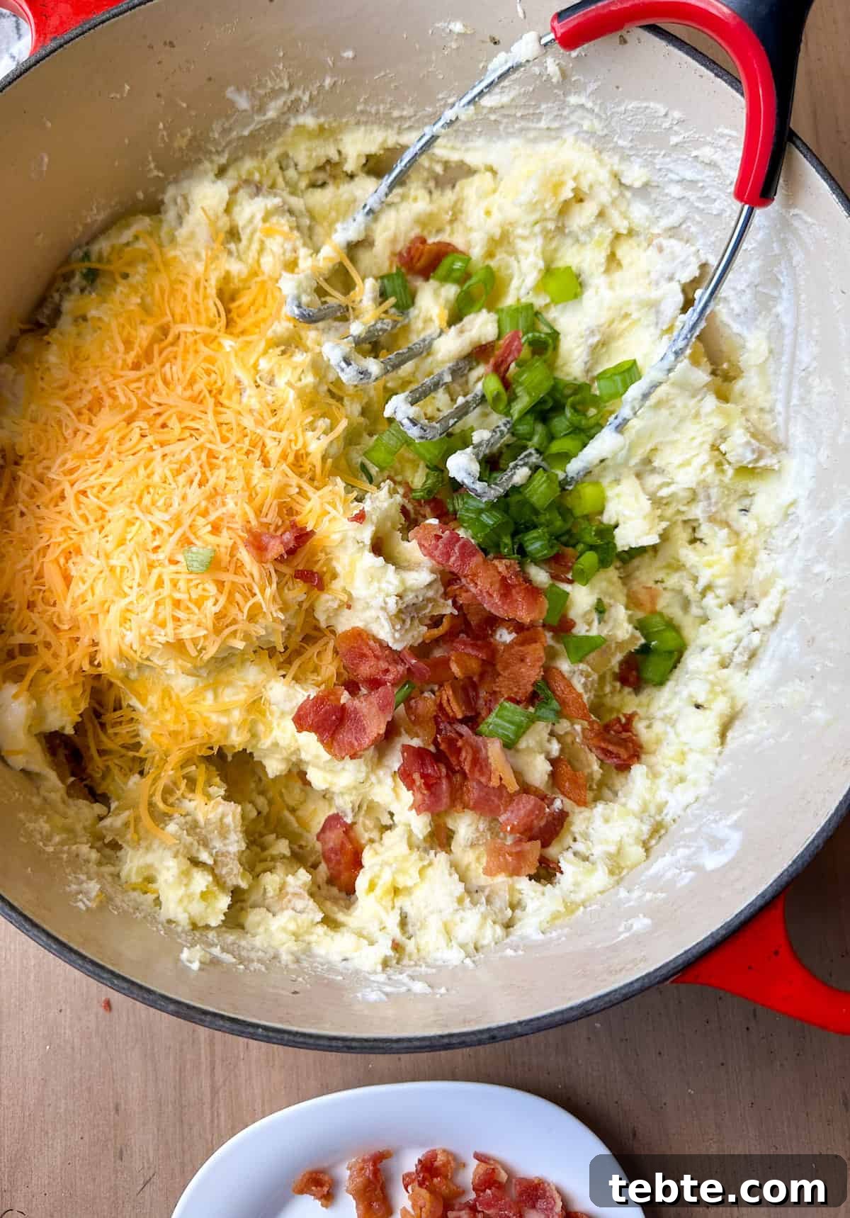Twice-Baked Potato Casserole: Loaded Mashed Potato Bake 7 Bacon, cheddar cheese and chopped onions on top of creamy mashed potatoes.