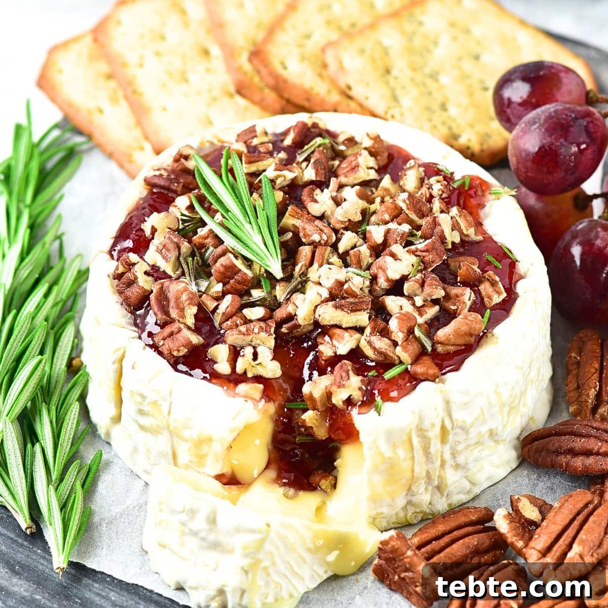 76 Gluten-Free Game Day Snacks to Share with Friends 5 Up close view of half-eaten baked brie with jam.