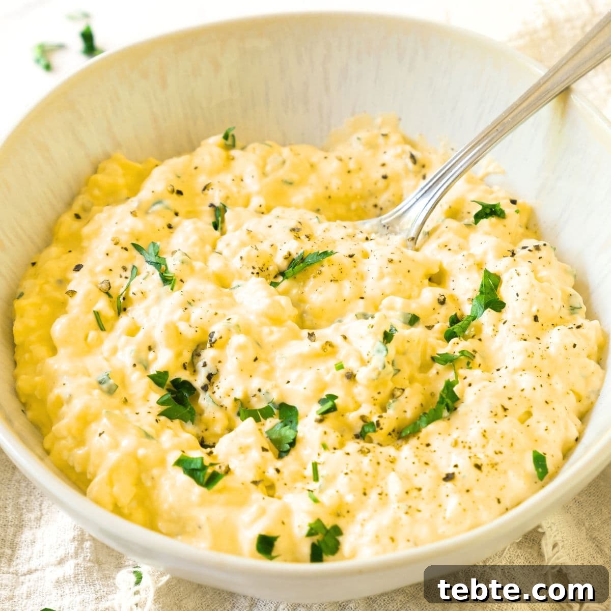 76 Gluten-Free Game Day Snacks to Share with Friends 9 A spoon in a bowl of egg salad.