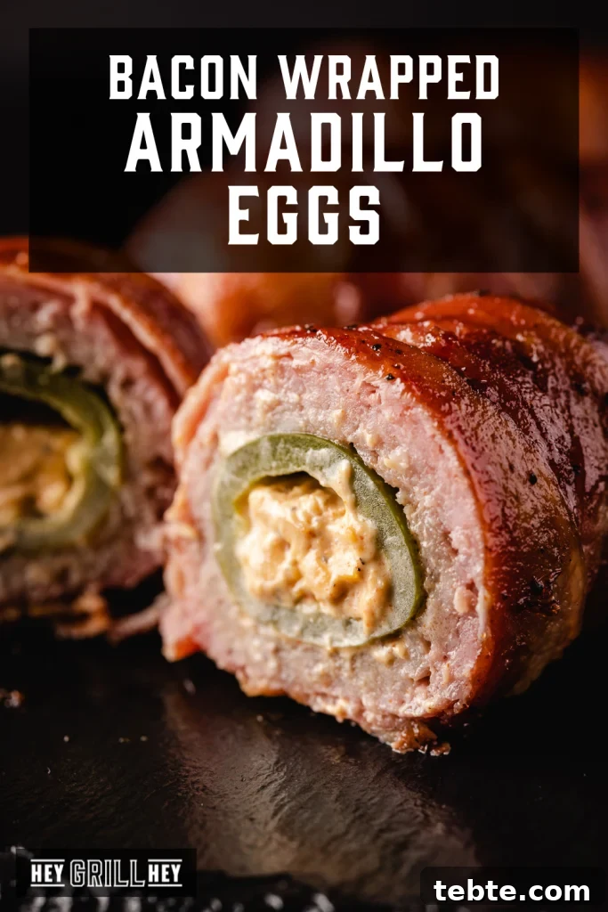 Smoky Bacon-Wrapped Armadillo Eggs: Juicy Jalapeño Poppers with Cream Cheese 2 Sliced bacon wrapped armadillo egg on a serving platter with text overlay - Bacon Wrapped Armadillo Eggs.