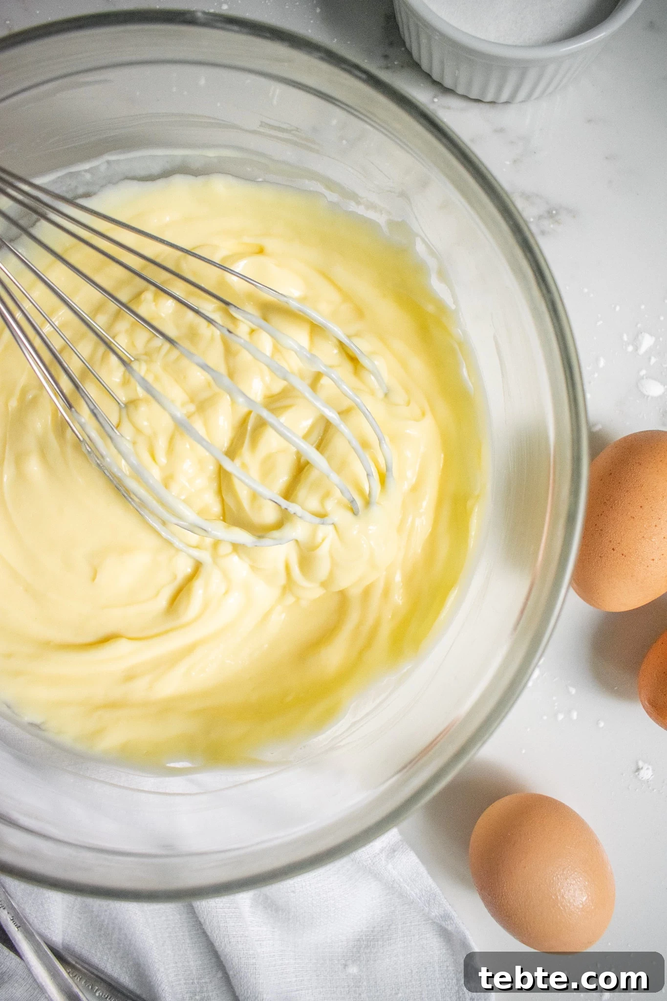 5 Essential Baking Tools Every Home Baker Needs 3 Pastry cream in a bowl with a whisk.