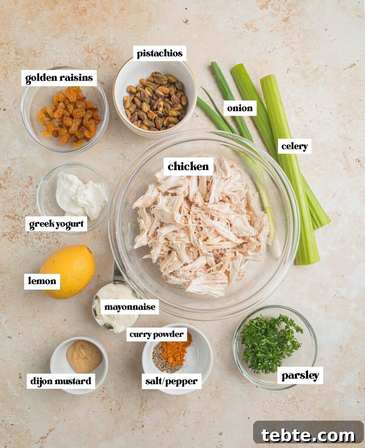 Creamy Curry Chicken Salad Recipe with Crunchy Apples and Almonds 3 Shredded chicken, celery, onion, parsley, mayo and other ingredients labeled.