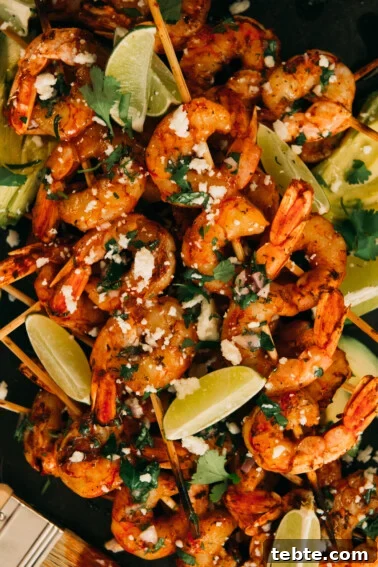 Crispy Halloumi Shrimp Saganaki with Tomato and Feta 15 Bbq shrimp skewers on platter with crumbled cotija, brushed with chimichurri and lime wedges as garnish