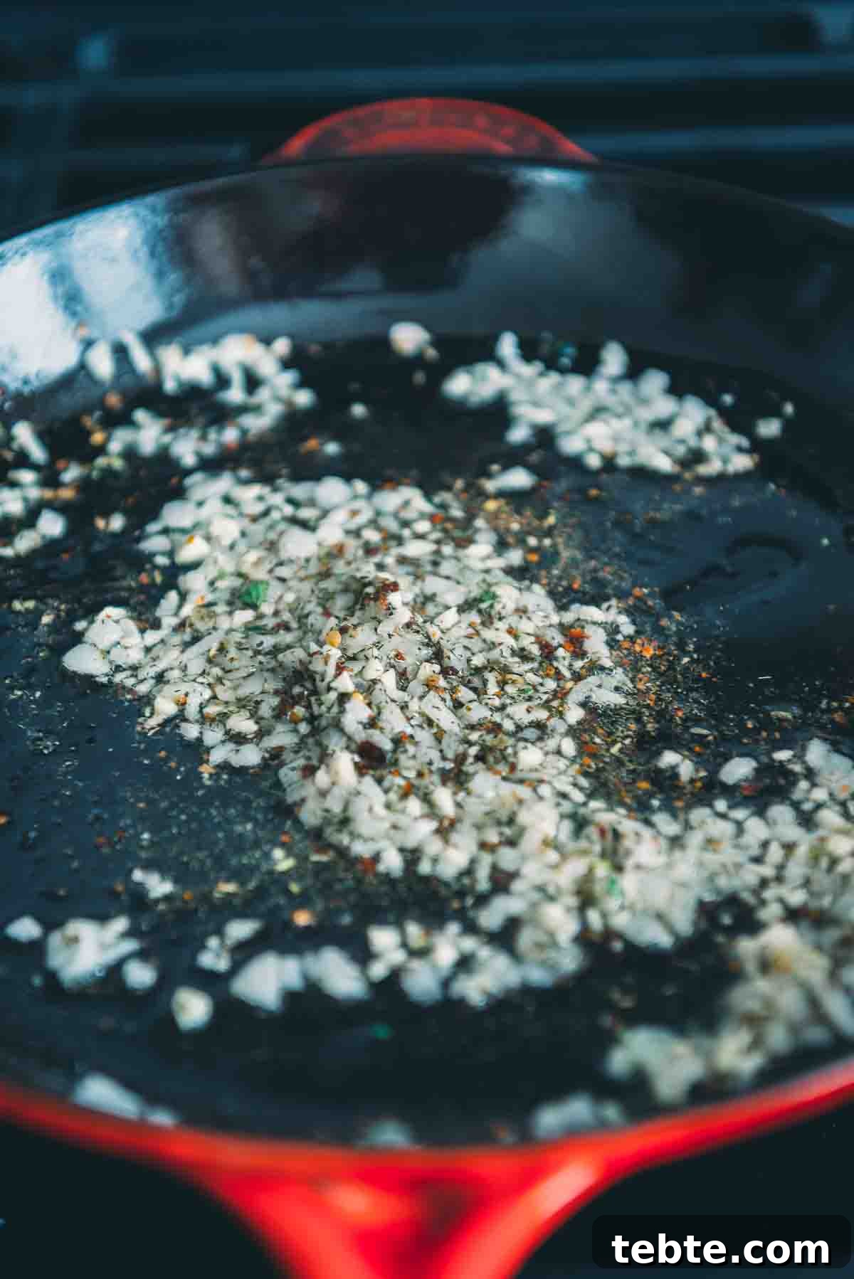 Crispy Halloumi Shrimp Saganaki with Tomato and Feta 5 Onion and herbs in the skillet.