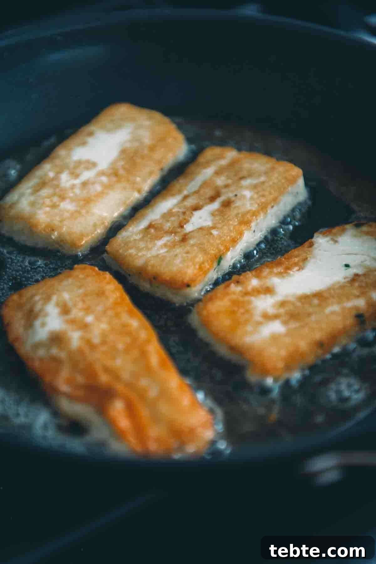 Crispy Halloumi Shrimp Saganaki with Tomato and Feta 10 Fried cheese in a pan.