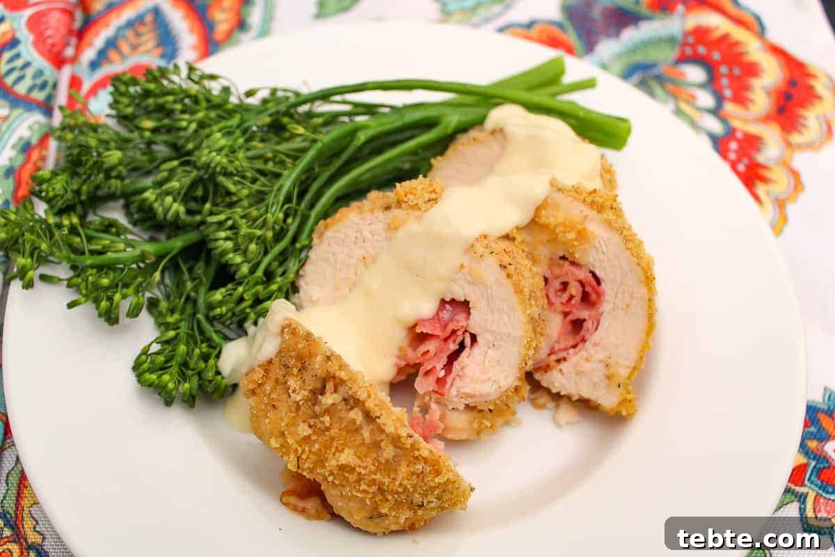 Safe Thawing Guide for Beef, Pork, Poultry & Seafood 3 Sliced chicken cordon bleu with dijon sauce and a side of broccolini on a plate