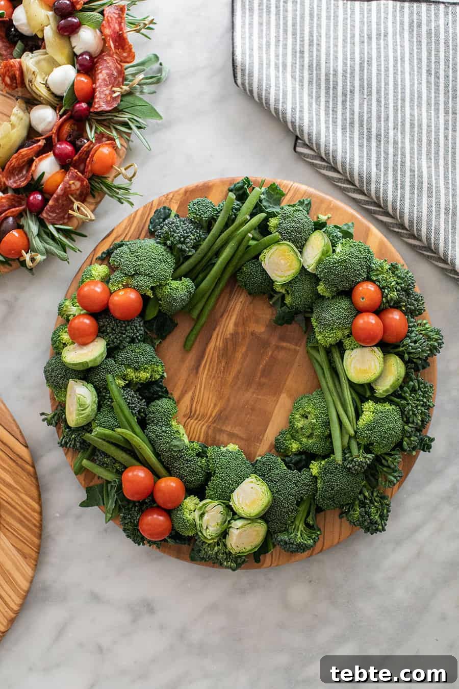 Crudite wreath with broccoli, green beans, Brussels sprouts, and cherry tomatoes.