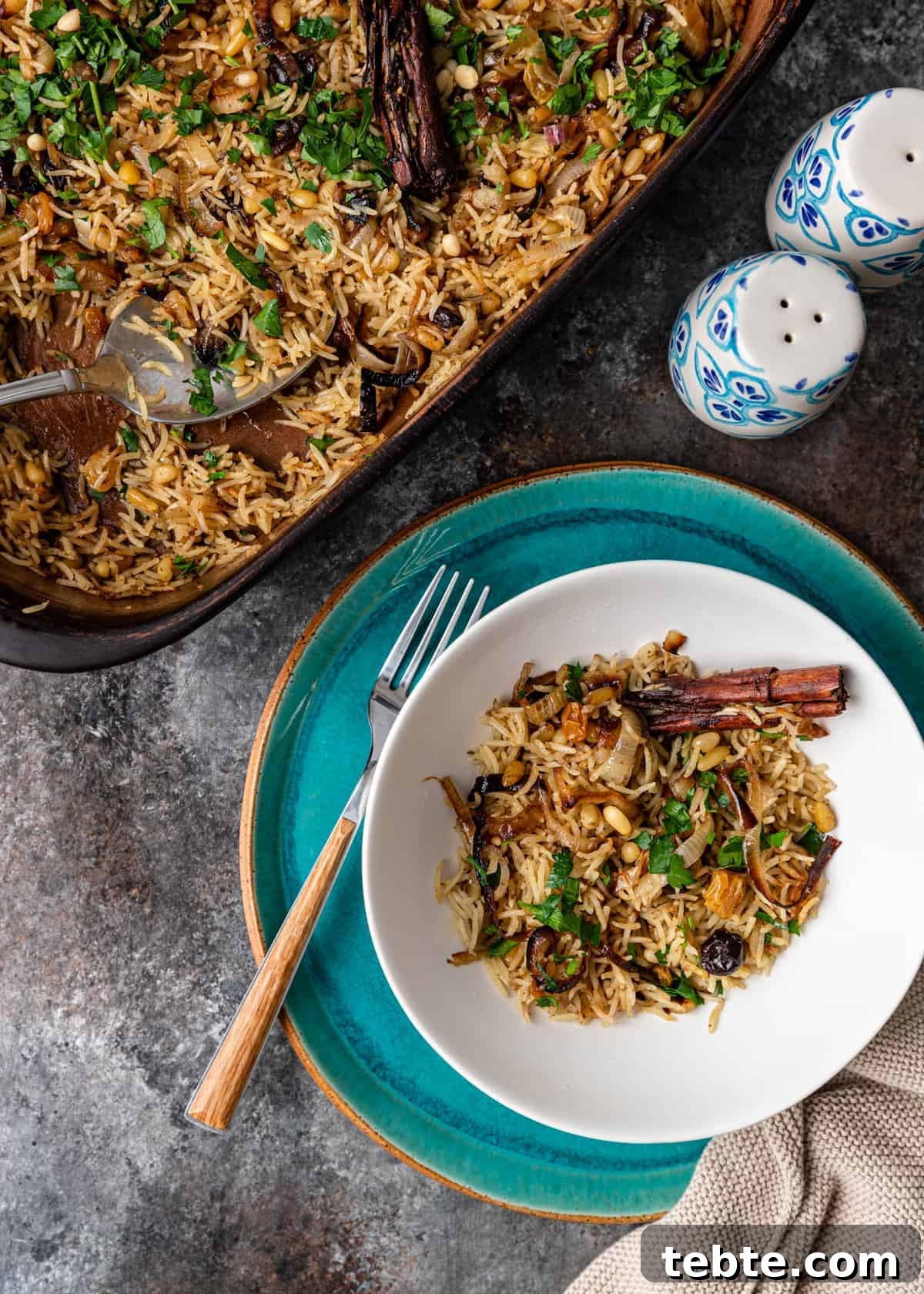 Authentic Middle Eastern Rice Pilaf Recipe with Aromatic Spices 10 overhead: Middle Eastern rice pilaf recipe in casserole dish and white bowl