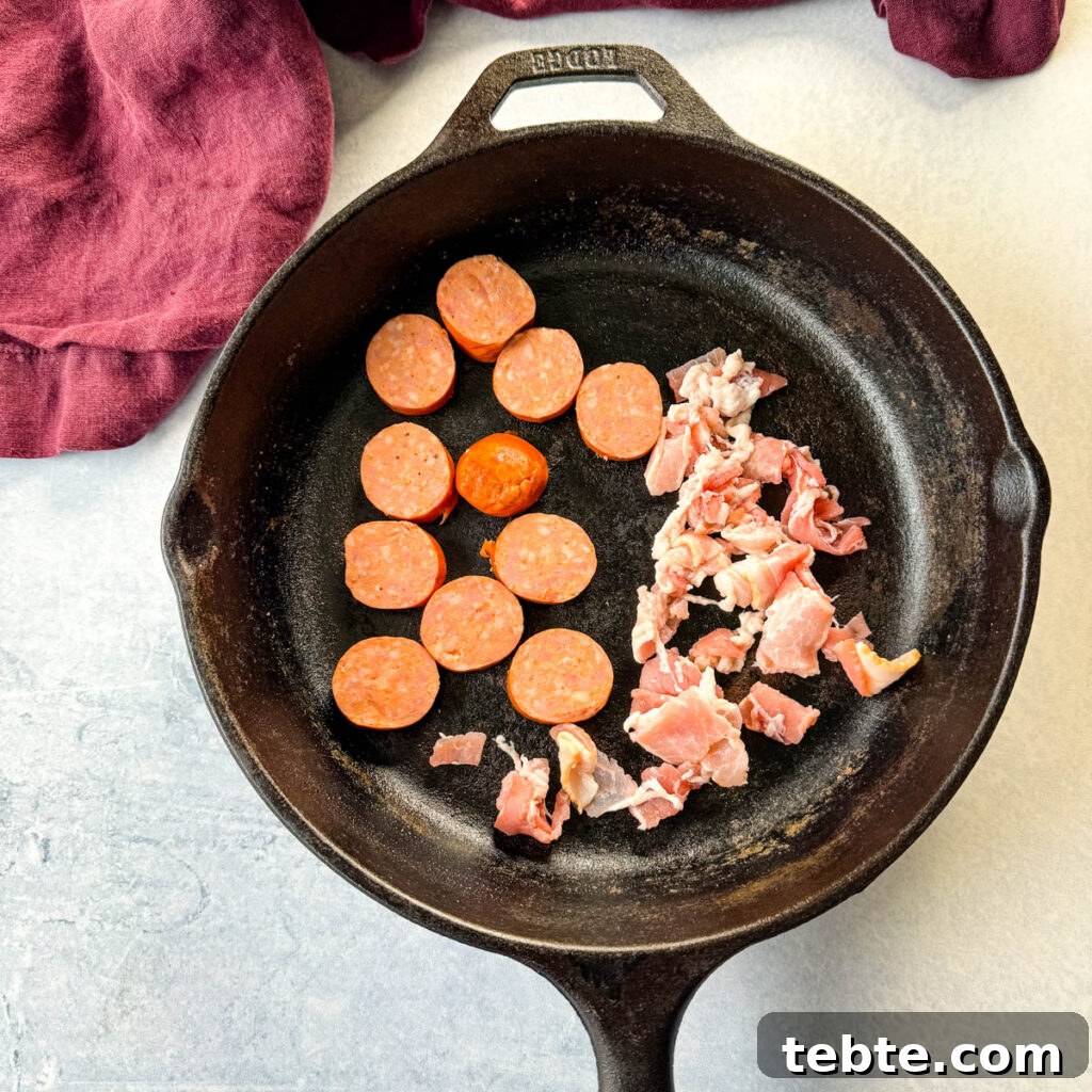 Classic Homemade Pork and Beans Recipe for Comforting Meals 6 uncooked sausage and bacon in a cast iron skillet