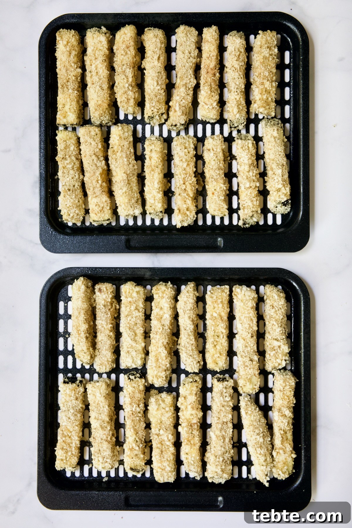 Crispy Air Fryer Eggplant Fries with Garlic Parmesan Dip 14 Two trays of eggplant fries before being fried in air fryer.