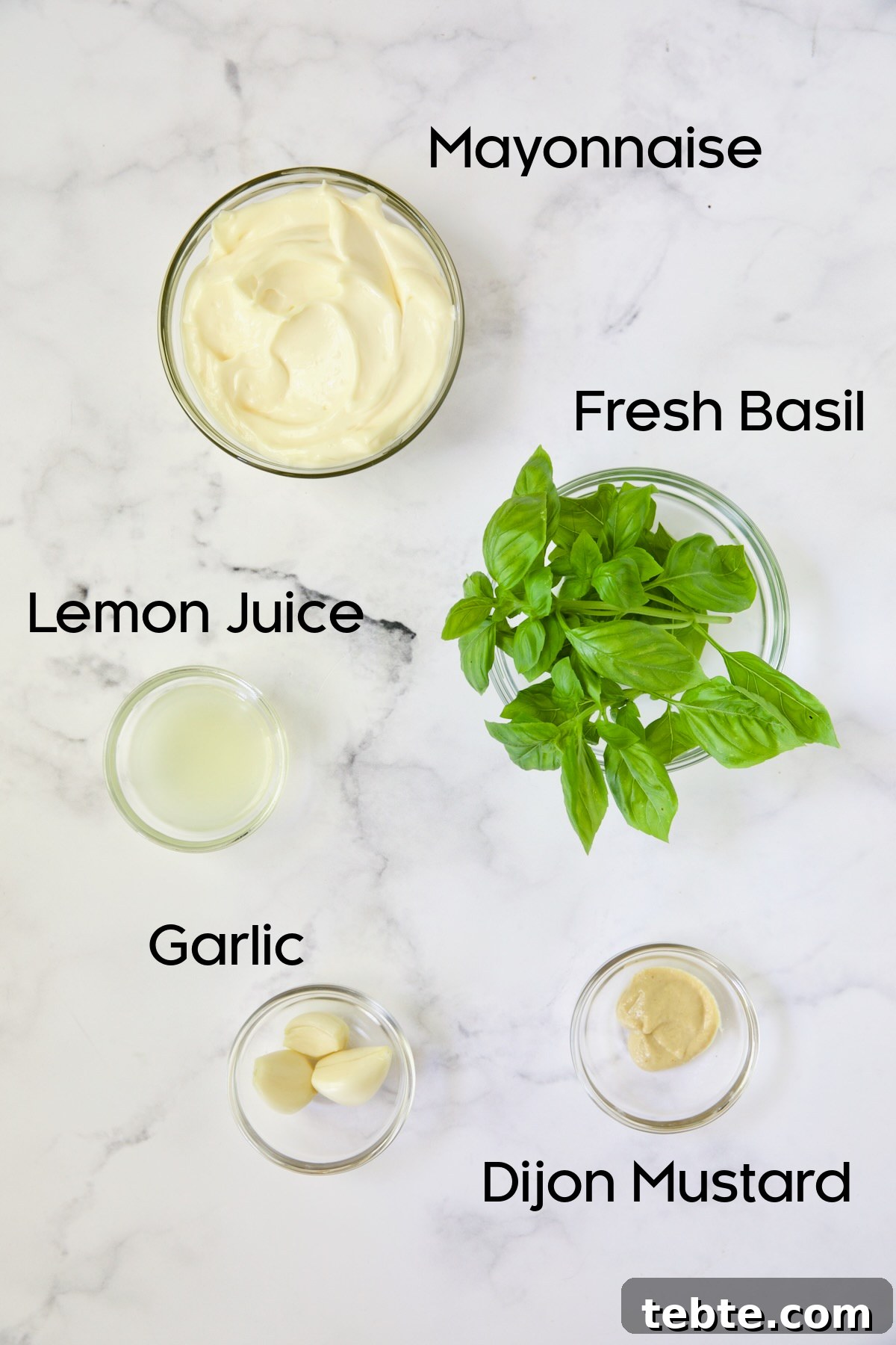Crispy Air Fryer Eggplant Fries with Garlic Parmesan Dip 5 Ingredients for Garlic Basil Aioli in glass bowls on white background.