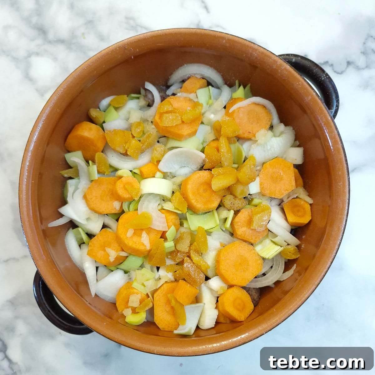 Carrots and chopped apricots layered over the onions.