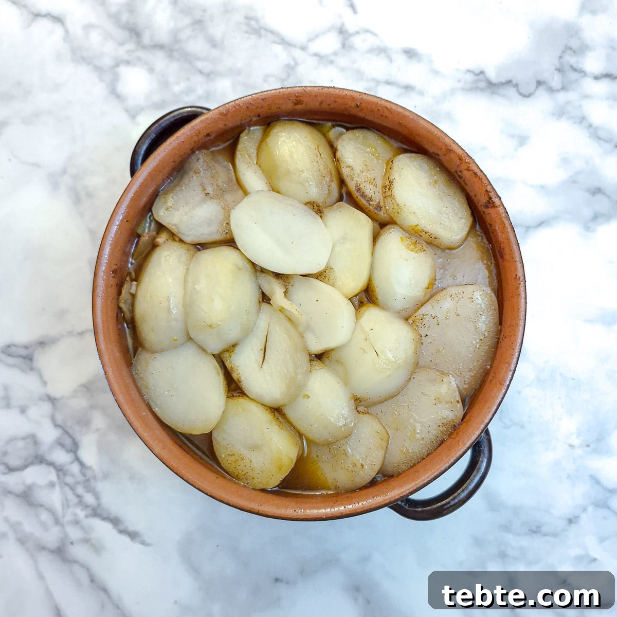 The lamb potjie after it has been in the oven for about 2 hours. The potatoes are very insipid looking and need to be browned.