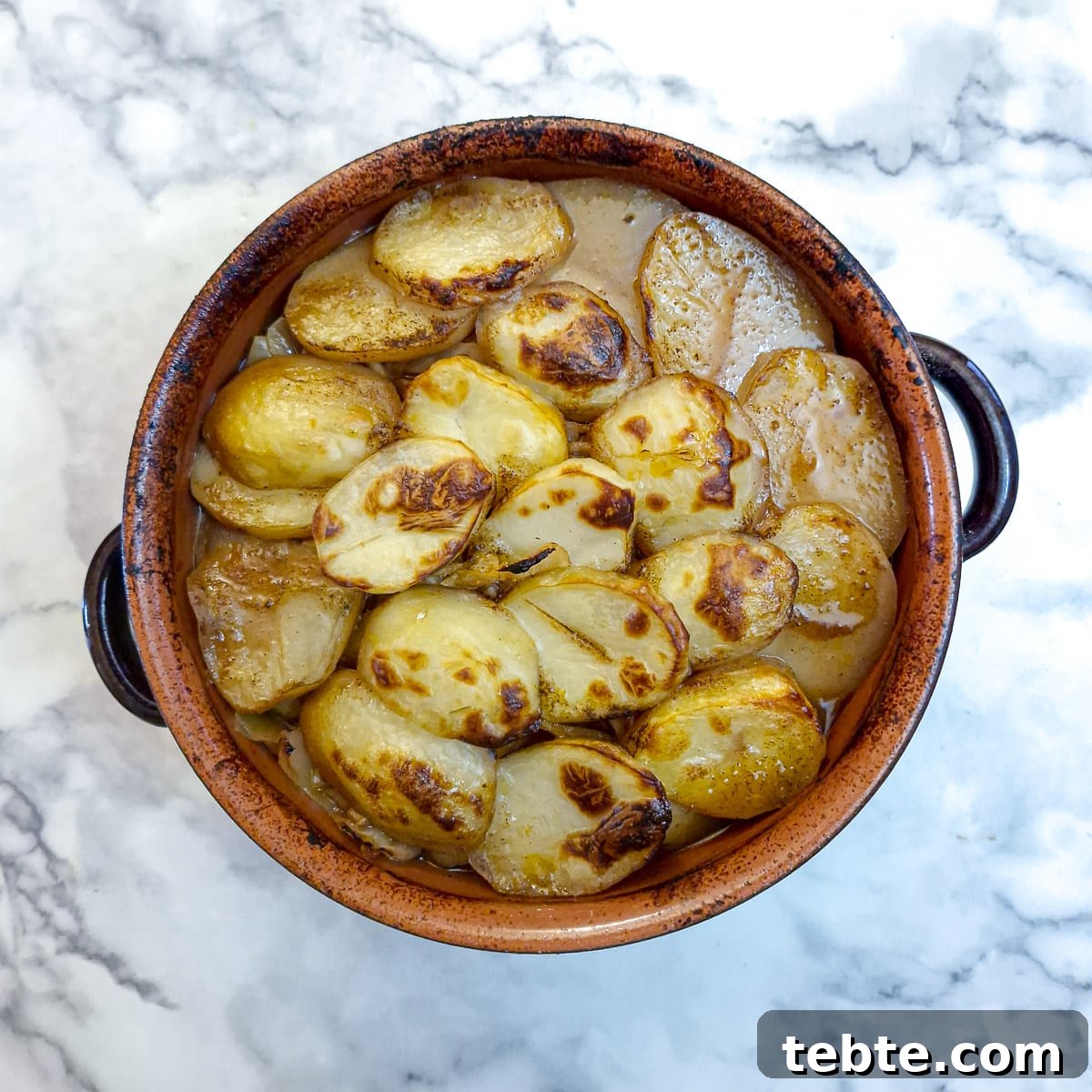 The finished lamb potjie with a layer of browned potatoes. It looks a lot more appetising!