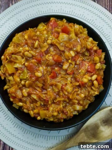 A black serving dish filled with spicy chakalaka.