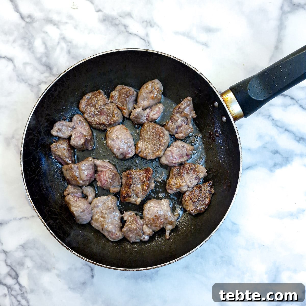 Fully browned lamb ready to be transferred to a casserole dish.