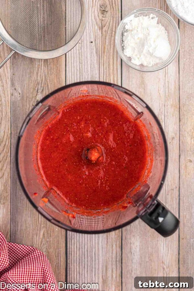 Creamy No-Bake Strawberry Cheesecake Recipe 5 Blending strawberries in a food processor