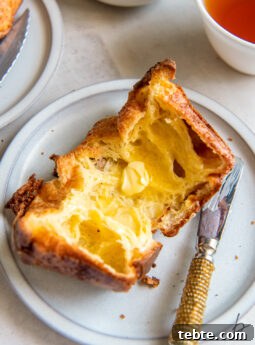 popover cut open with butter spread inside.