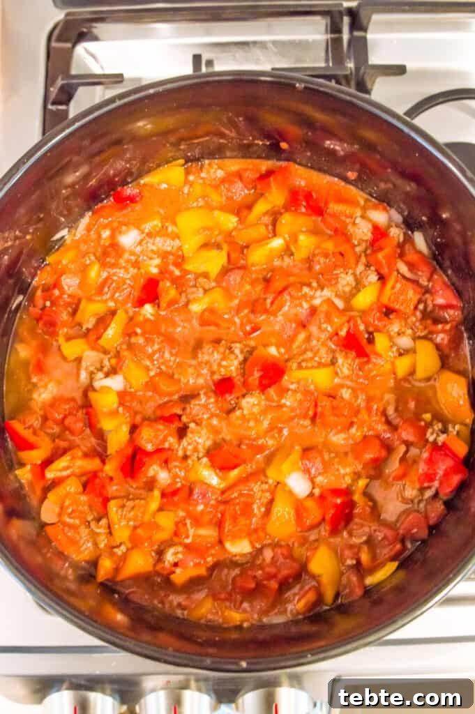 A pot on the stovetop with chili in it.