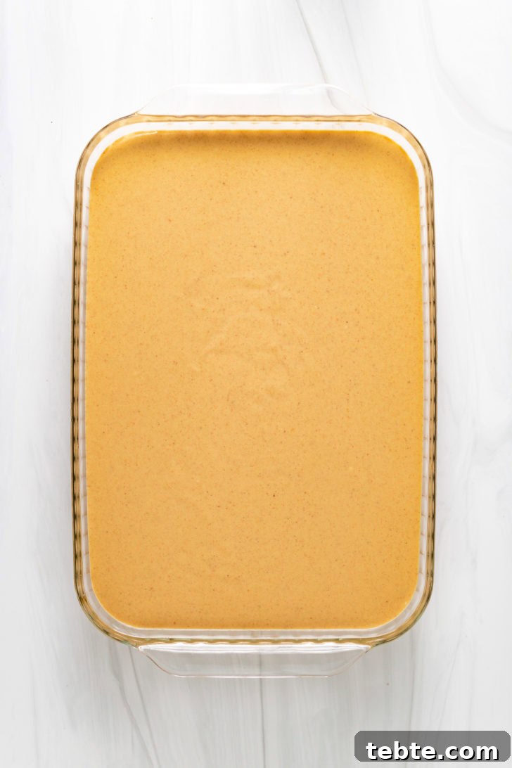 Top down view of unbaked cheesecake bars.
