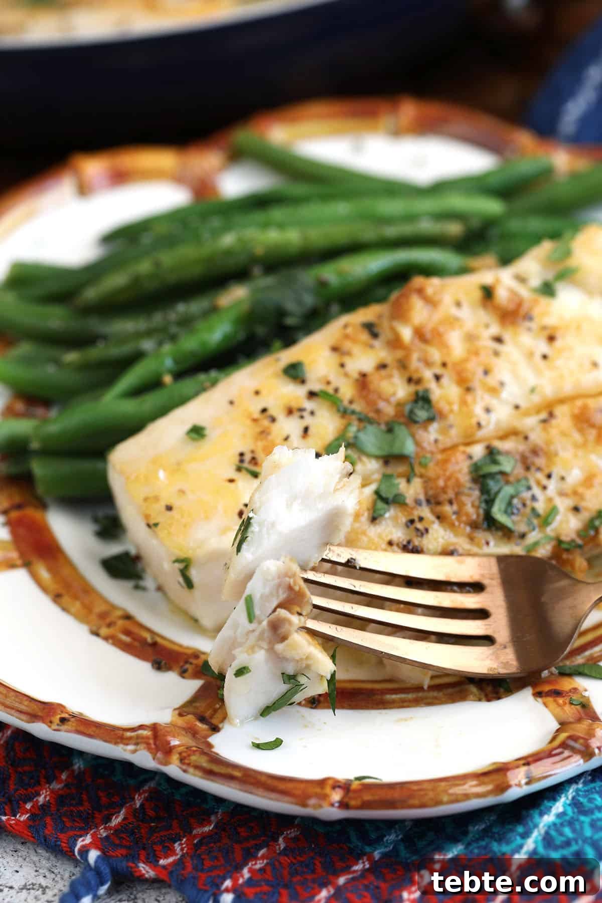 Miso Garlic Butter Mahi Mahi Recipe with Lemon and Herbs 2 Fork cutting into mahi mahi on plate