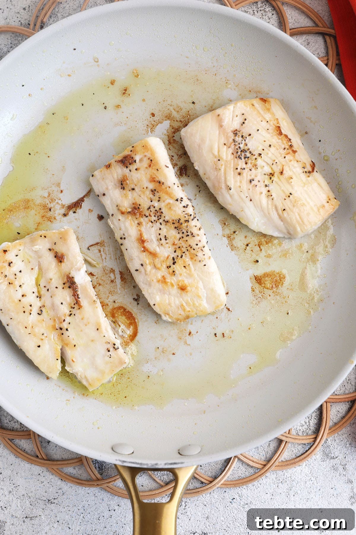 Miso Garlic Butter Mahi Mahi Recipe with Lemon and Herbs 4 Overhead view of mahi mahi cooking in skillet
