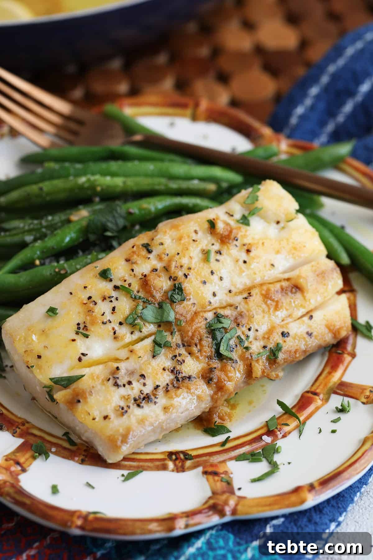 Miso Garlic Butter Mahi Mahi Recipe with Lemon and Herbs 9 Mahi mahi with miso garlic butter sauce on plate with green beans