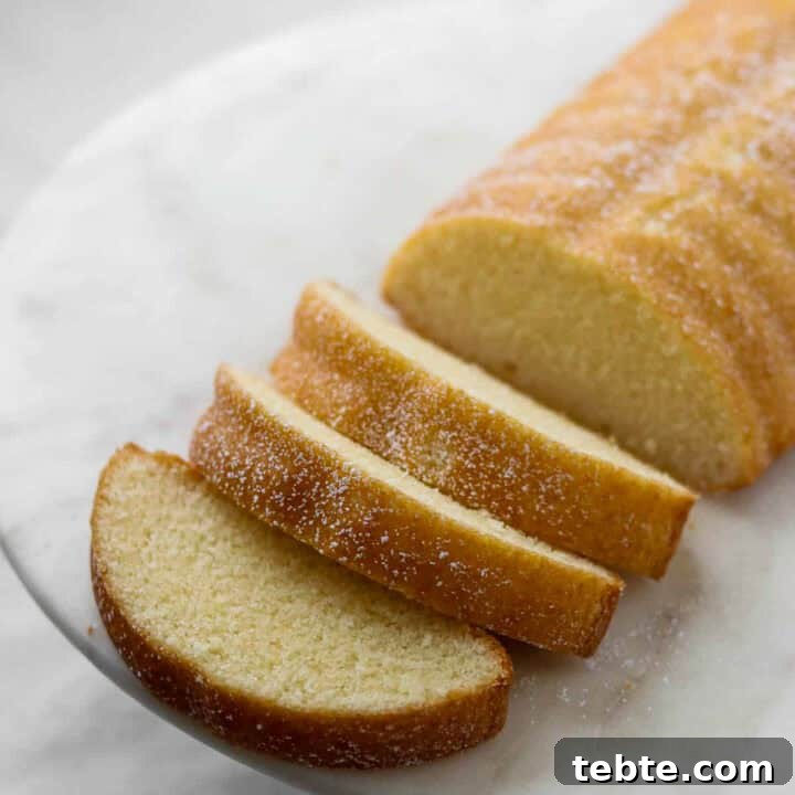 Sliced Swedish Almond Cake on a marble plate.
