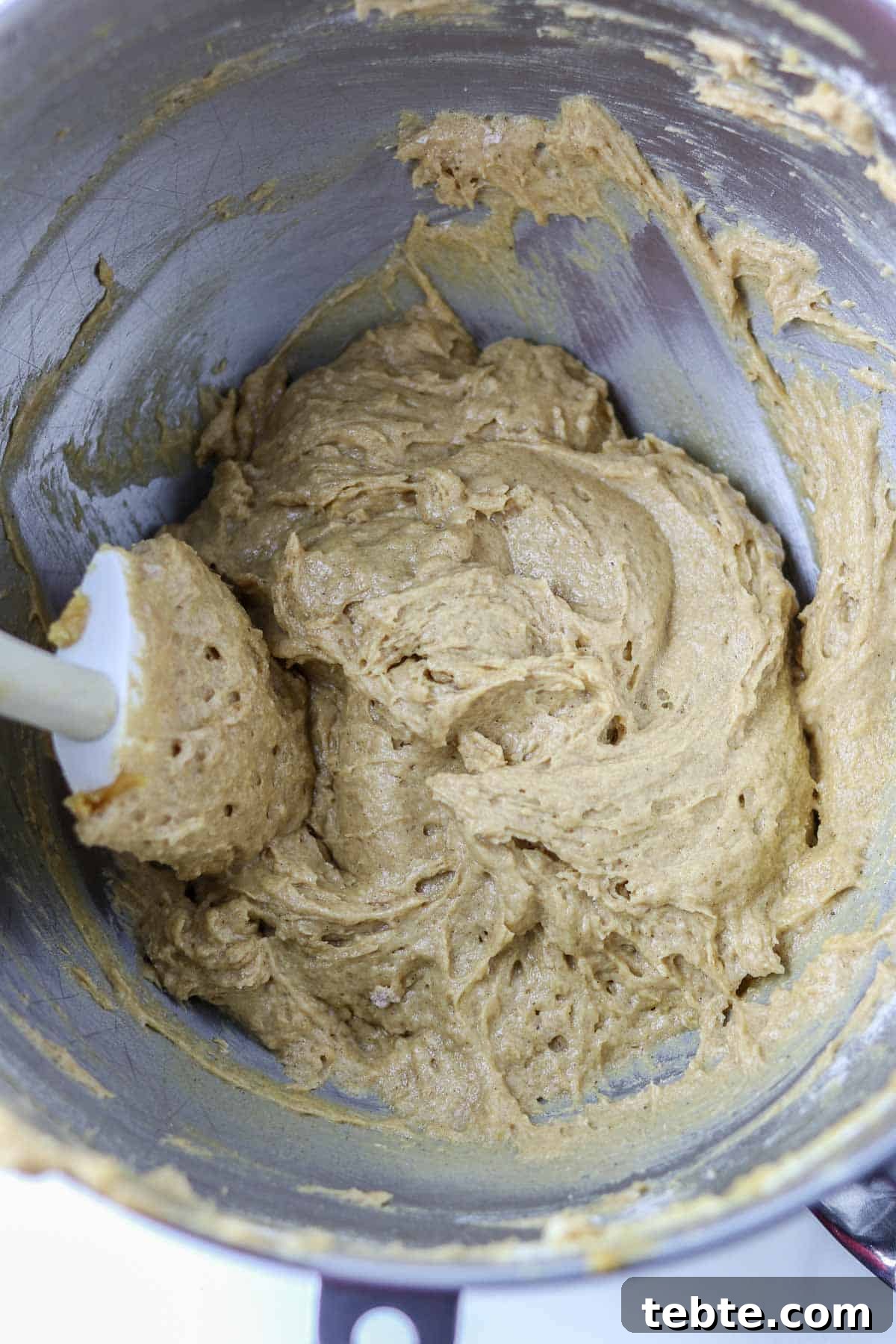 Swedish Spice Cake batter in a metal bowl with a rubber spatula.